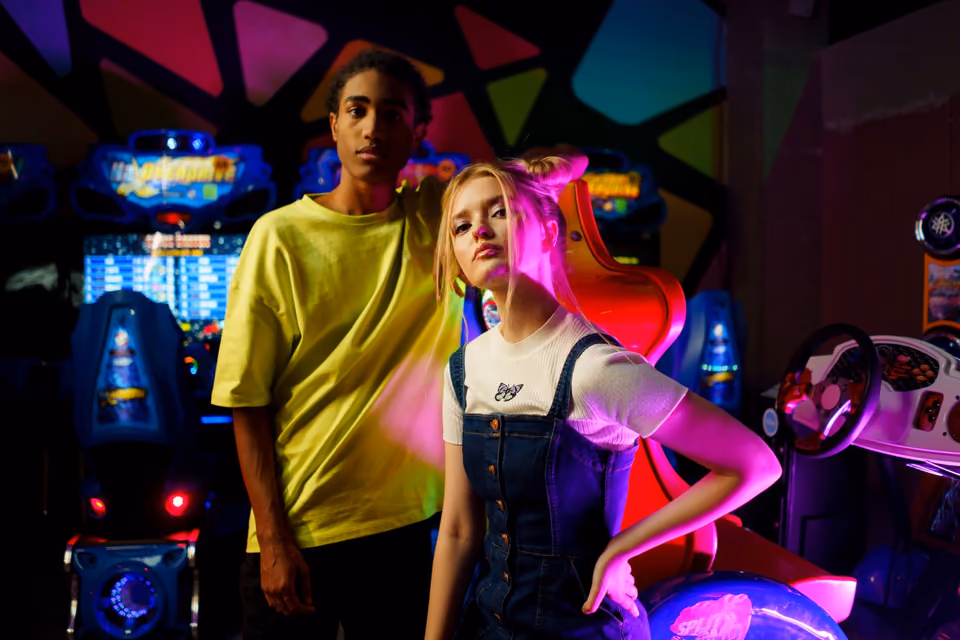 A couple in an arcade, looking at the camera